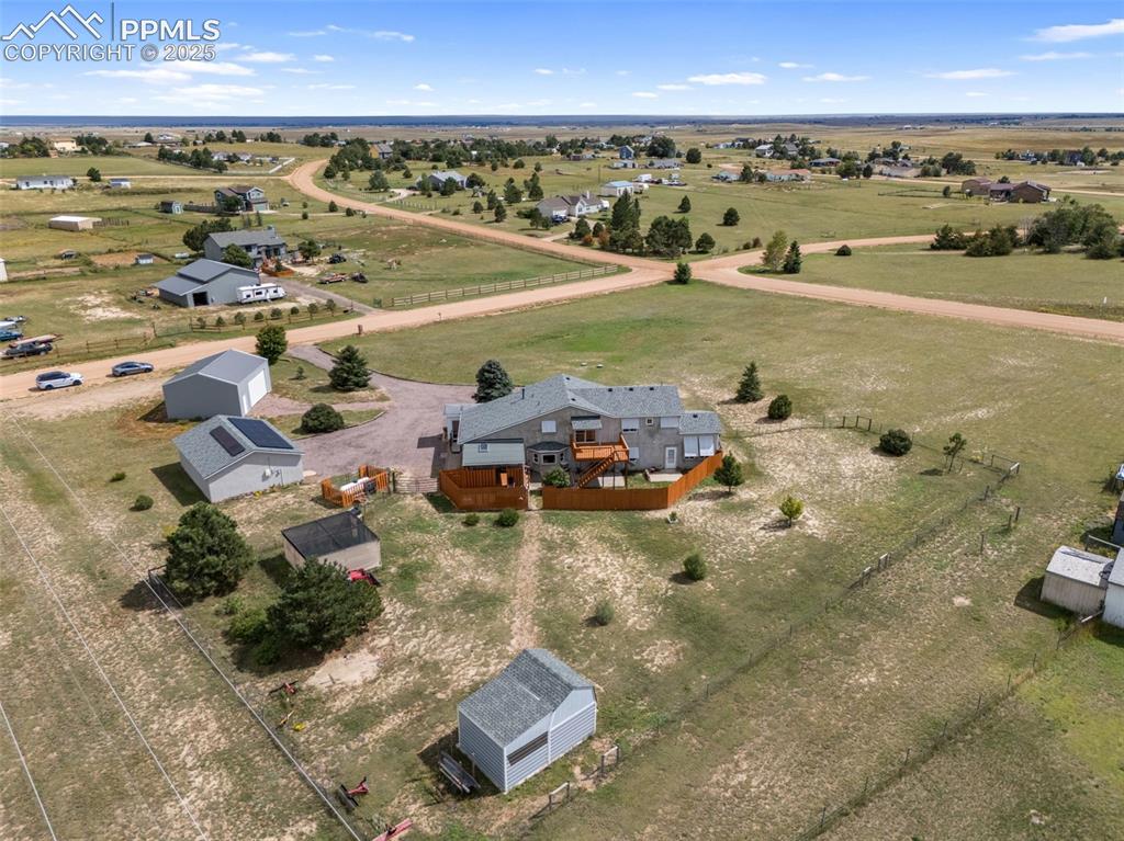 Image 37 of 38: Property overview showcasing acreage and outbuildings