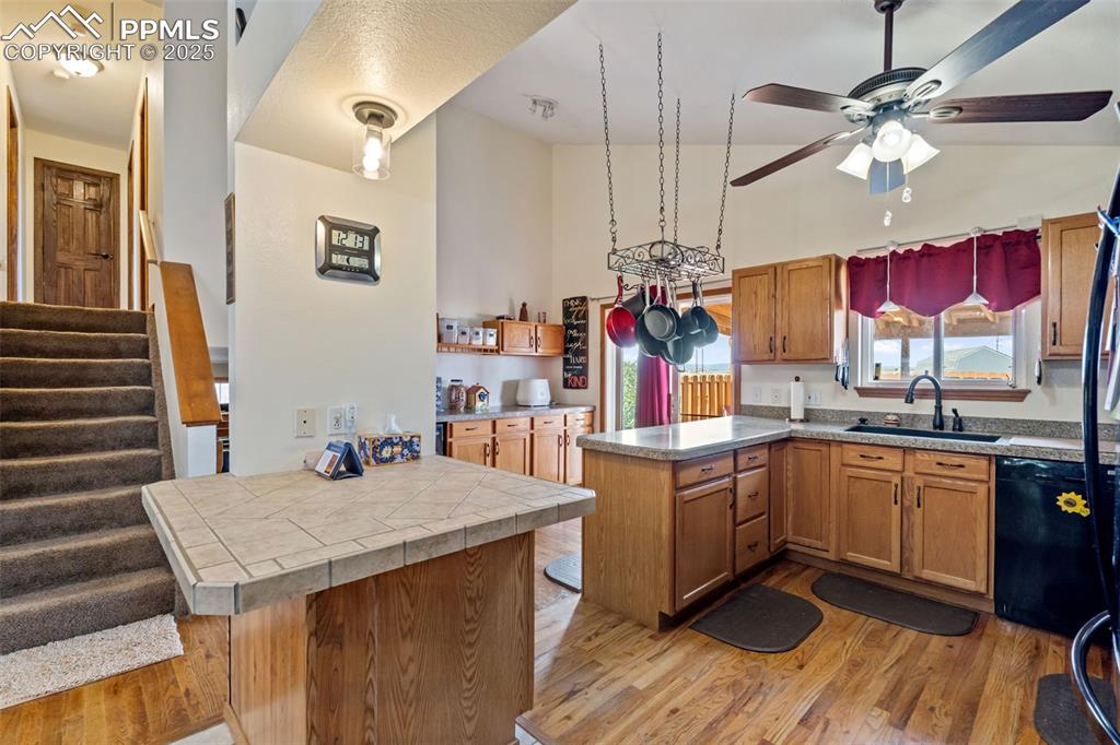 Image 6 of 38: Spacious kitchen with breakfast bar and vaulted ceilings
