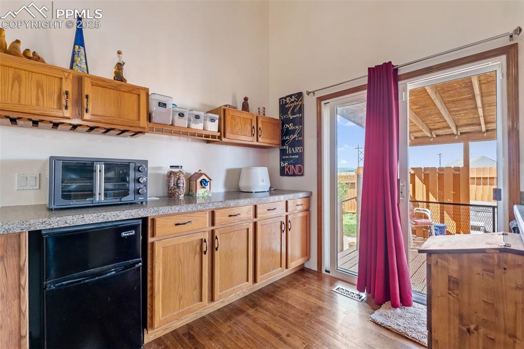 Image 7 of 38: Walkout from kitchen to deck for indoor-outdoor living