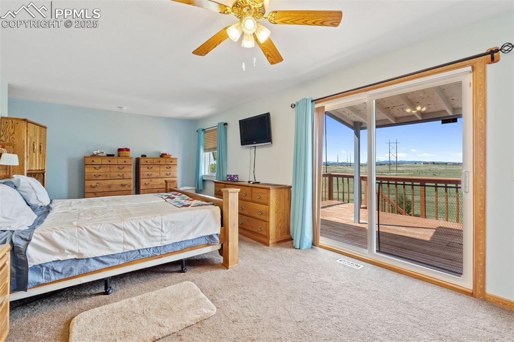 Image 9 of 38: Upper-level master suite with private deck and mountain views
