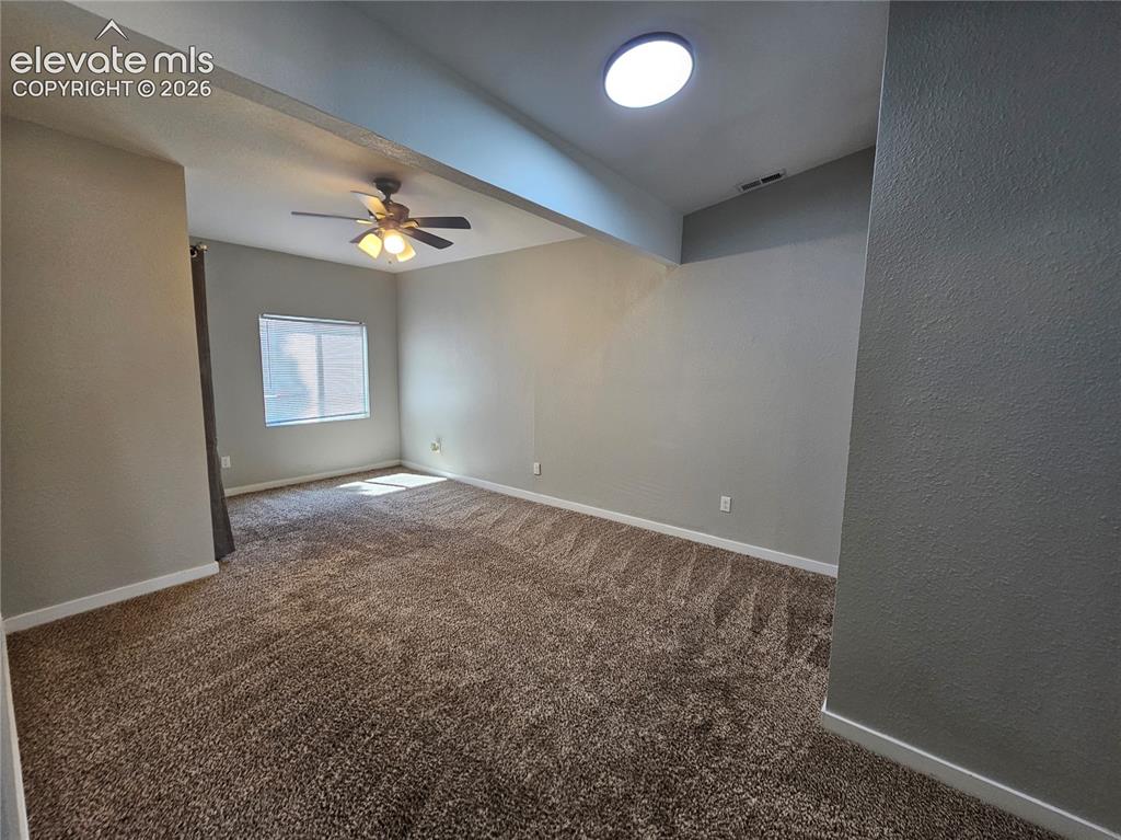 Image 3 of 15: Carpeted interior space featuring a ceiling fan with integrated lighting, a