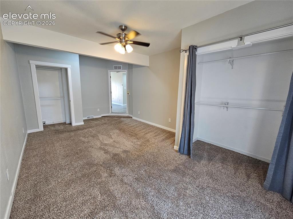 Image 4 of 15: Neutral-toned carpet flooring, a ceiling fan with light fixture, and light 