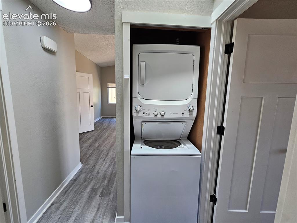 Image 8 of 15: Dedicated laundry closet with stacked washer and dryer unit