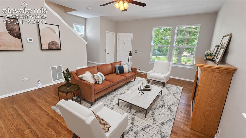 Image 2 of 27: Wood-finish flooring throughout the main living area, complemented by light