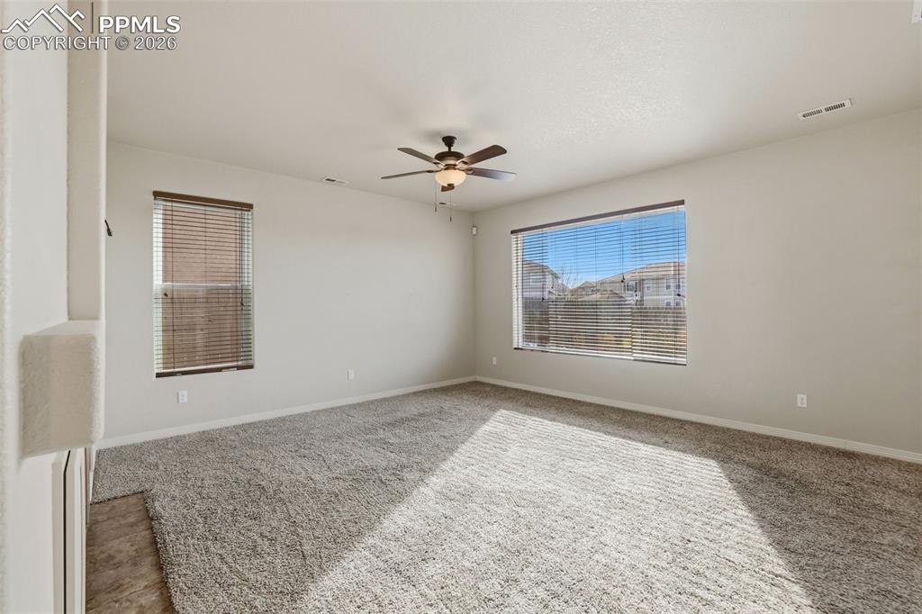 Image 11 of 39: Carpeted spare room featuring a ceiling fan and baseboards