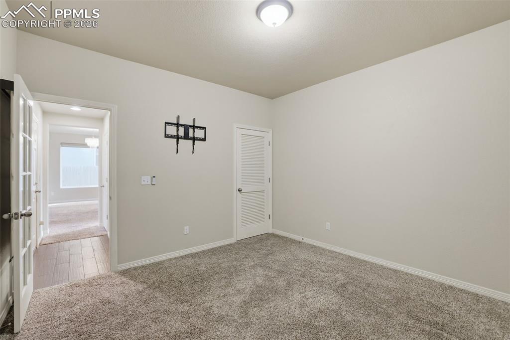 Image 22 of 39: Unfurnished room with carpet and baseboards