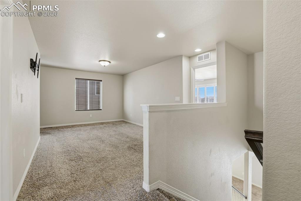 Image 24 of 39: Carpeted empty room with baseboards and recessed lighting