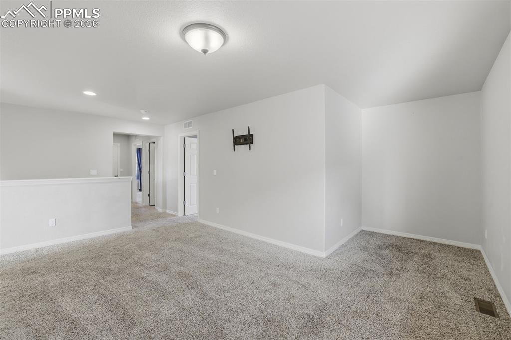 Image 25 of 39: Unfurnished room with light colored carpet and recessed lighting