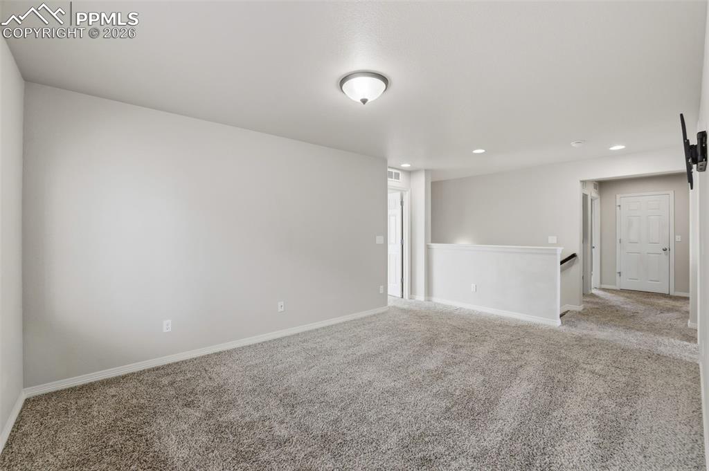 Image 26 of 39: Unfurnished room with carpet flooring and recessed lighting