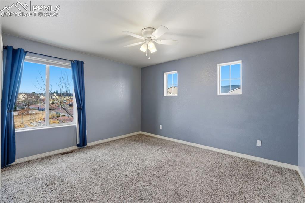 Image 35 of 39: Spare room featuring carpet flooring and a ceiling fan