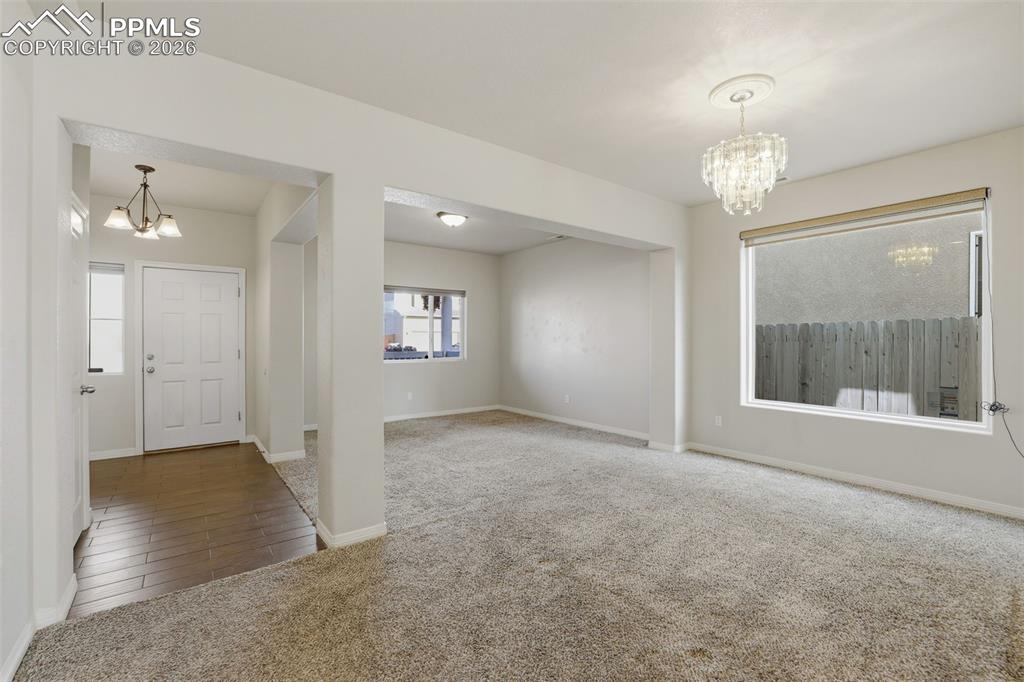 Image 6 of 39: Entryway featuring a chandelier and carpet