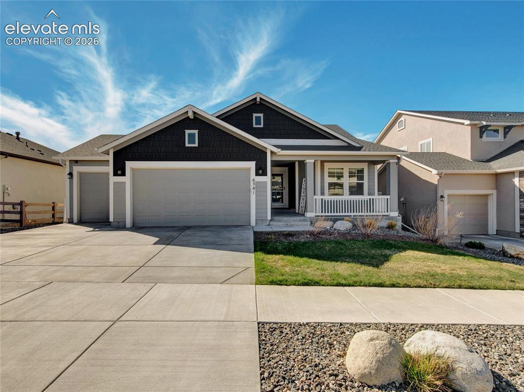 Caption: Single-story residence featuring a covered front porch with white railings