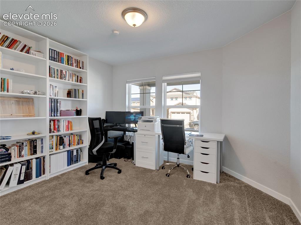 Image 10 of 17: Built-in white shelving system featuring multiple storage compartments