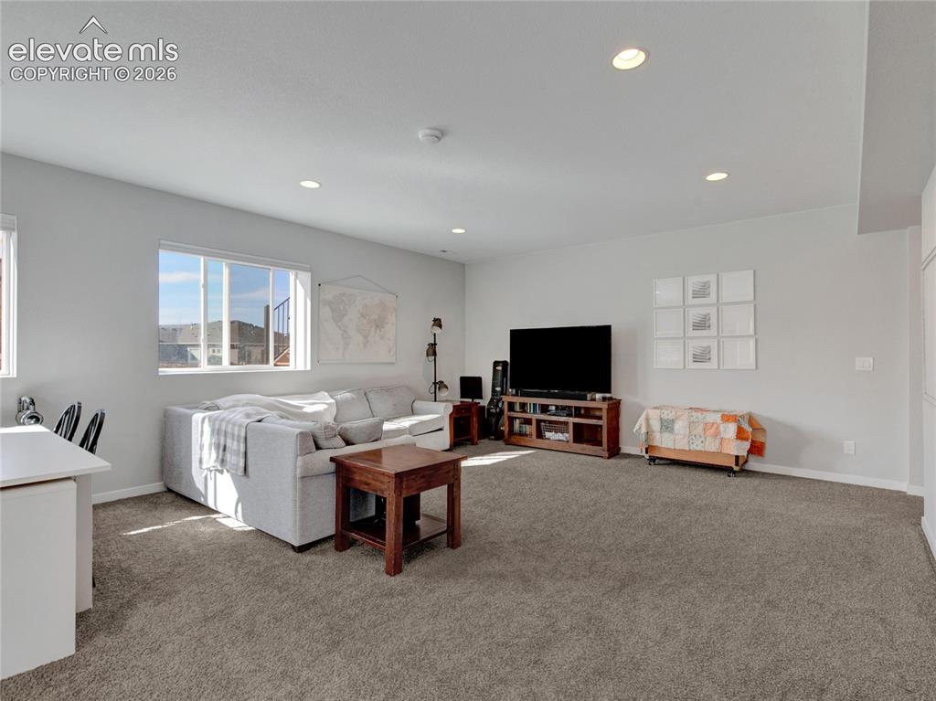 Image 12 of 17: Spacious room featuring neutral carpeting, recessed ceiling lighting, and l