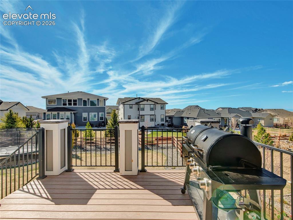 Image 16 of 17: Spacious outdoor deck featuring composite decking, black metal railing, and