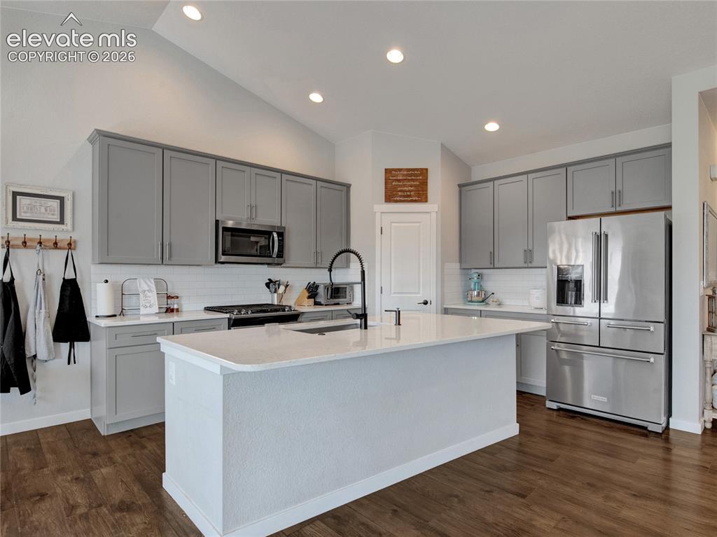 Image 5 of 17: Kitchen featuring a central island, light gray cabinetry, stainless steel a