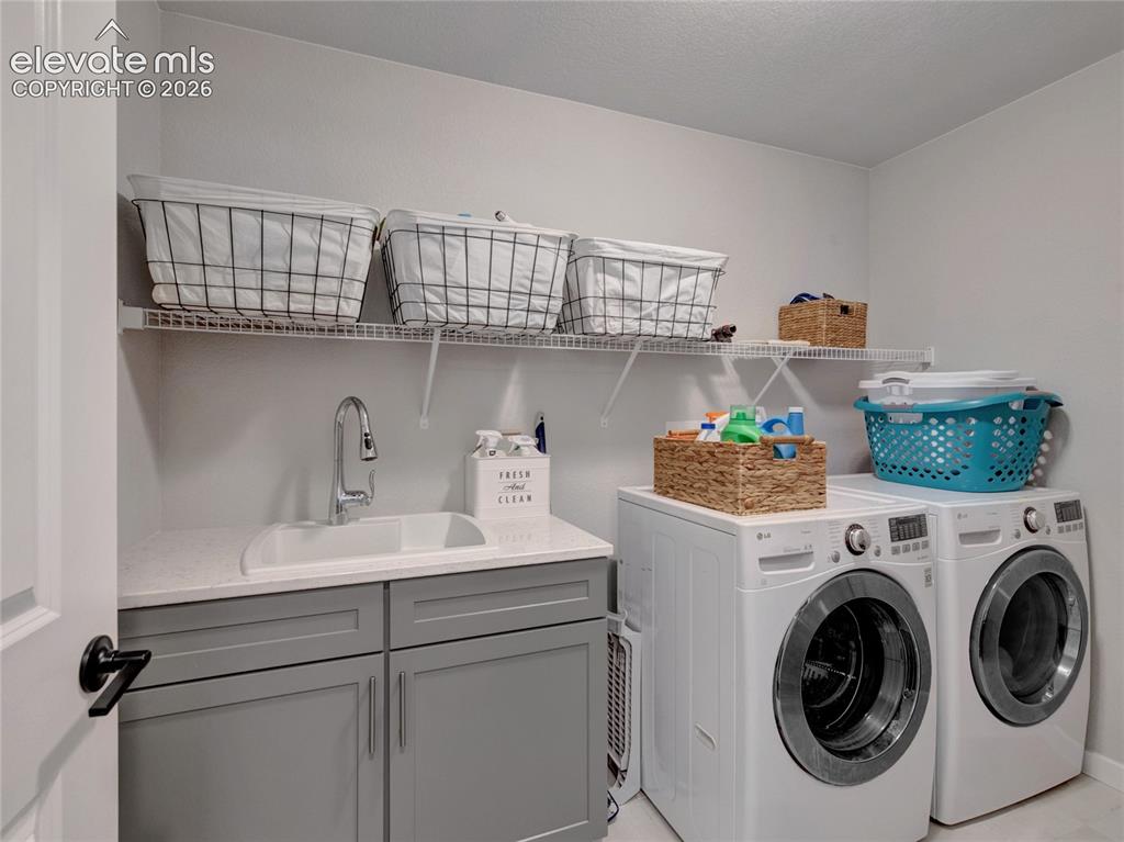 Image 9 of 17: Dedicated laundry room featuring a utility sink with a high-arc faucet, qua