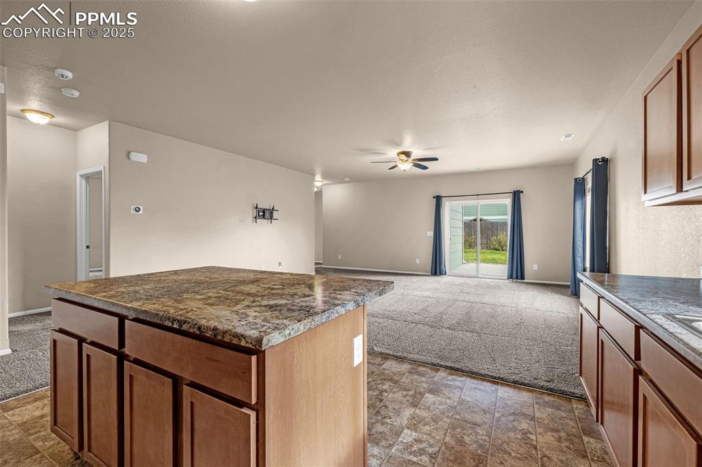 Image 11 of 28: Kitchen view opening up to the expansive walk-out Family Room.