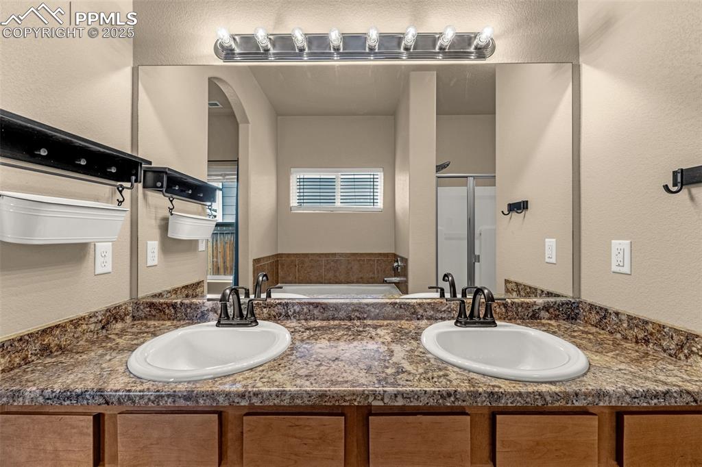 Image 18 of 28: Dual sinks, smooth counters, shaker style storage, large soaking tub and st