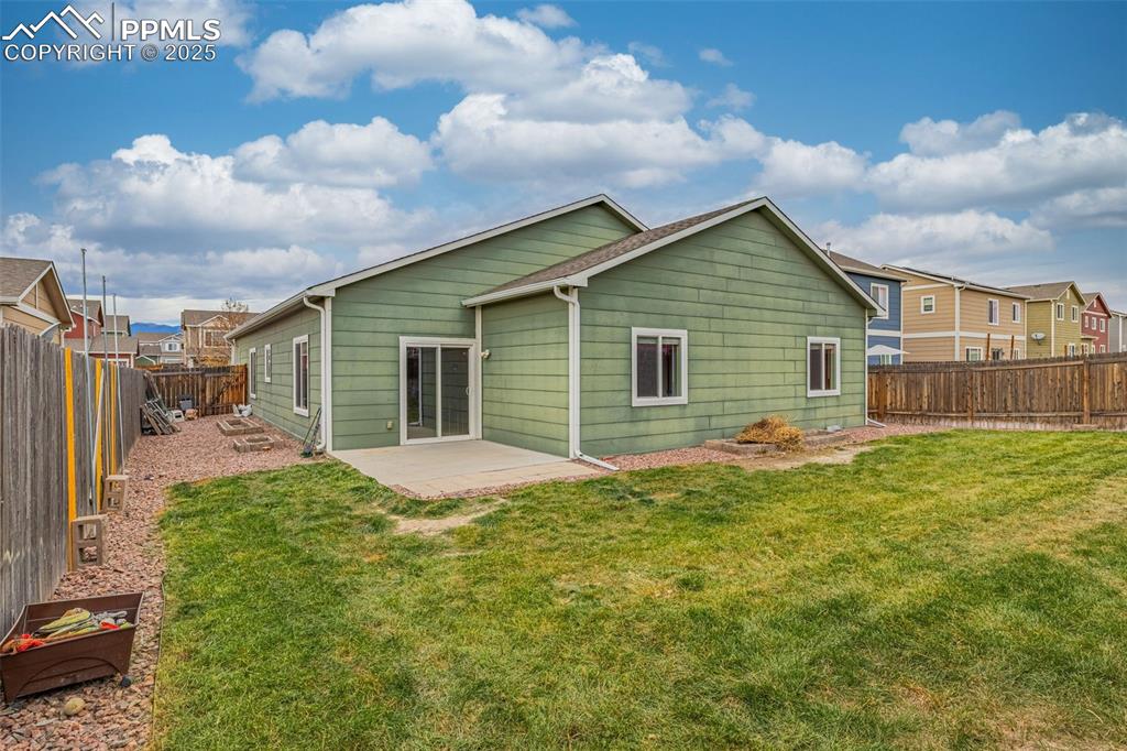 Image 22 of 28: Spacious patio, ample room for growing or dog run, WiFi enabled sprinkler s