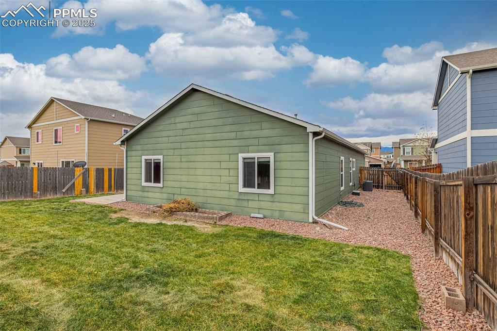 Image 23 of 28: Fully fenced yard keeps loved ones safer, ample room for future storage she