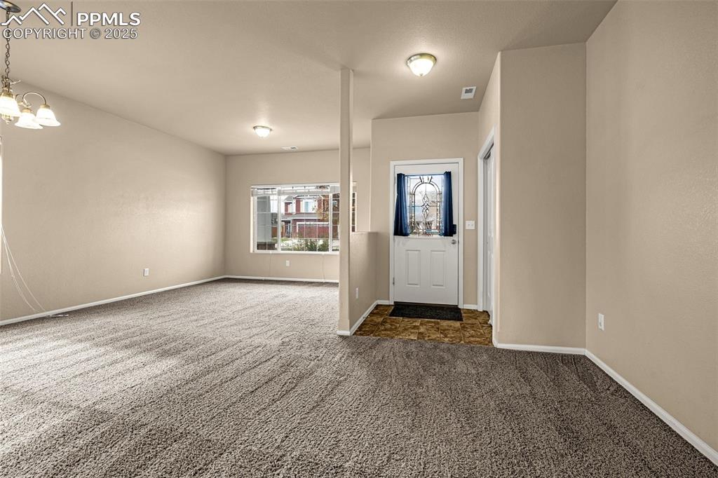 Image 4 of 28: Front Entry and Living/Dining Room combo OR make it an office/flex area.