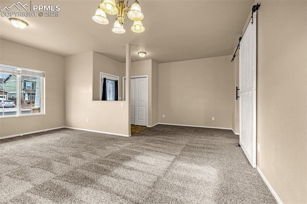 Image 6 of 28: Another view of the Living room with large windows allowing a flow of natur