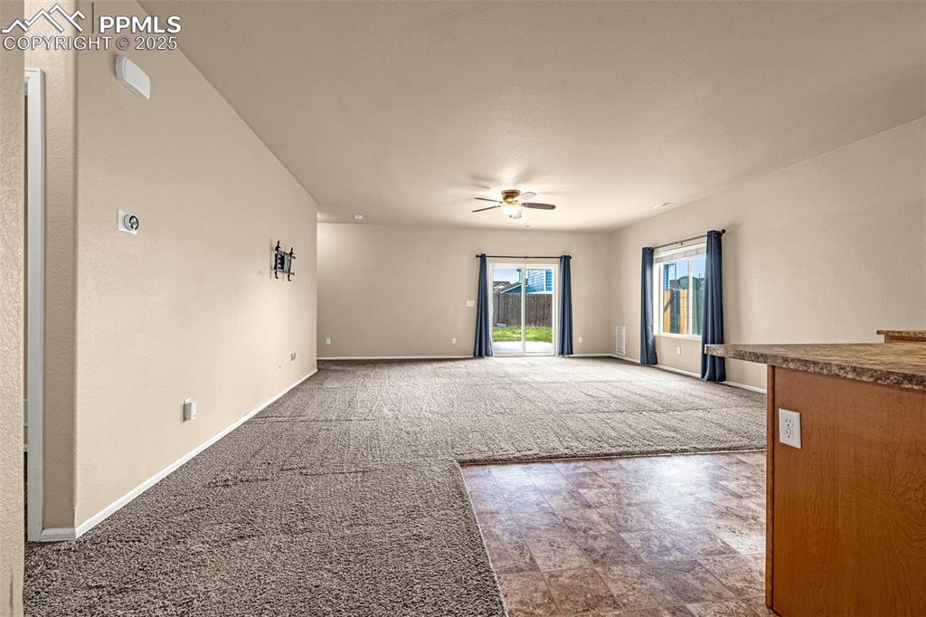 Image 7 of 28: Past the barn door is an expansive Family Room and Kitchen.