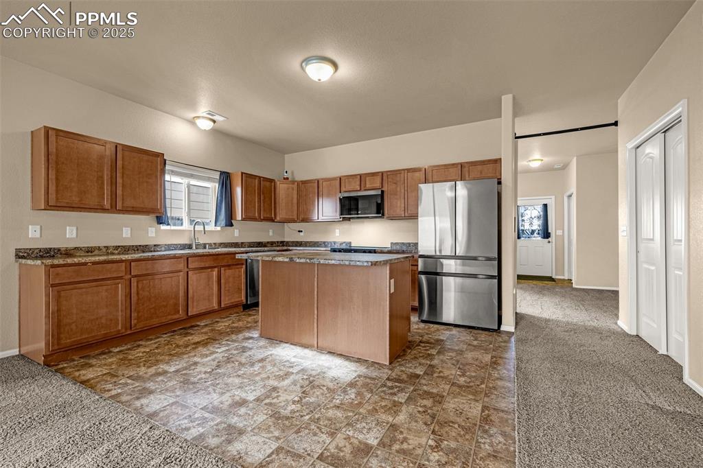 Image 8 of 28: Spacious Kitchen offers center island with seating and plenty of counter an