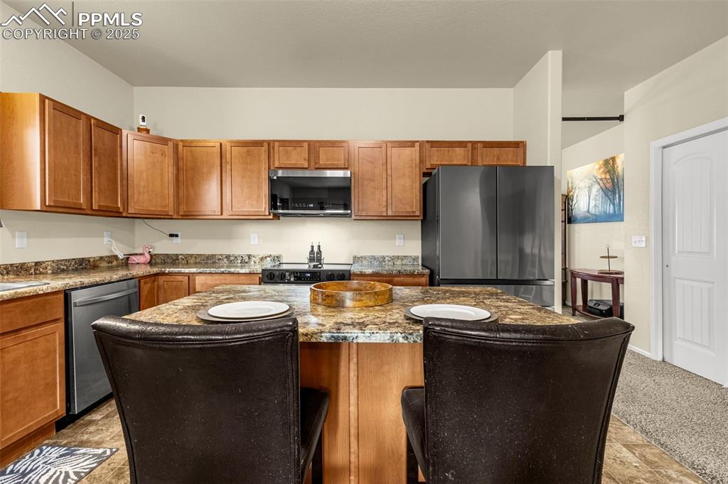 Image 9 of 28: Spacious Kitchen offers center island with seating and plenty of counter an