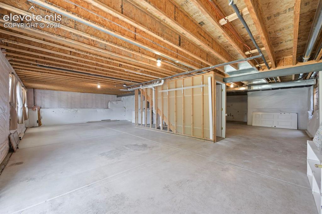 Image 13 of 45: Dining area featuring tile-look flooring and a contemporary chandelier