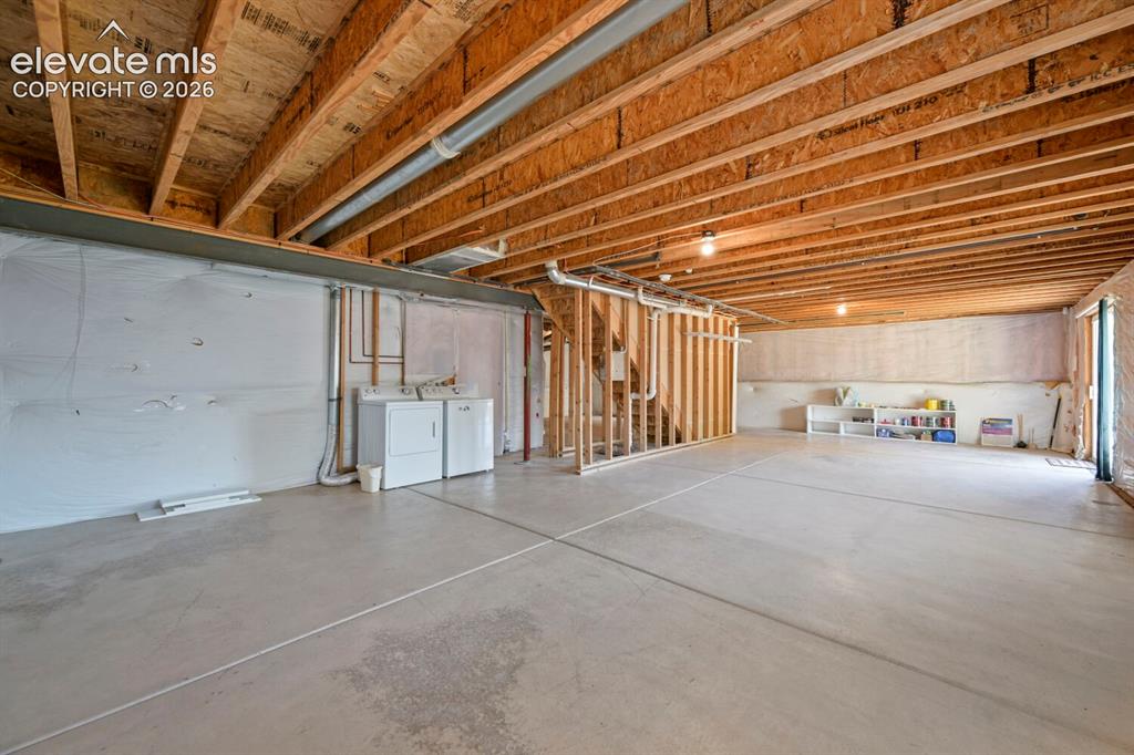 Image 14 of 45: Single-story residence featuring tan siding, a covered front porch, and a t