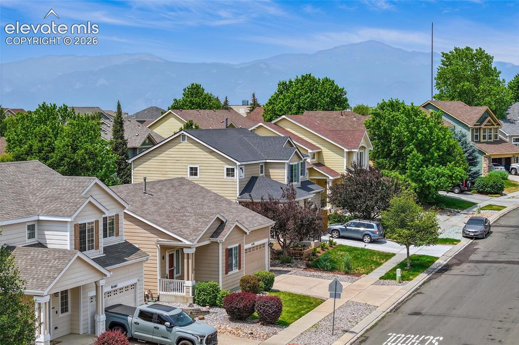 Image 39 of 45: Two-story residence with a multi-level deck and stairs leading to the groun