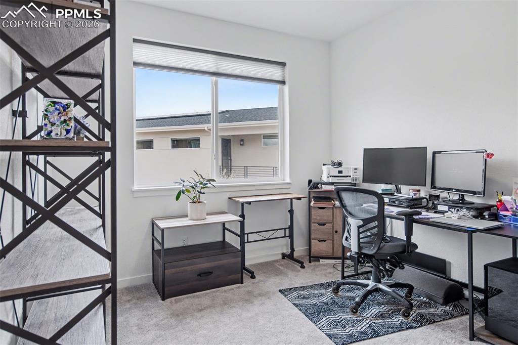 Image 16 of 37: Bathroom featuring double vanity, a tile shower, and light tile patterned f