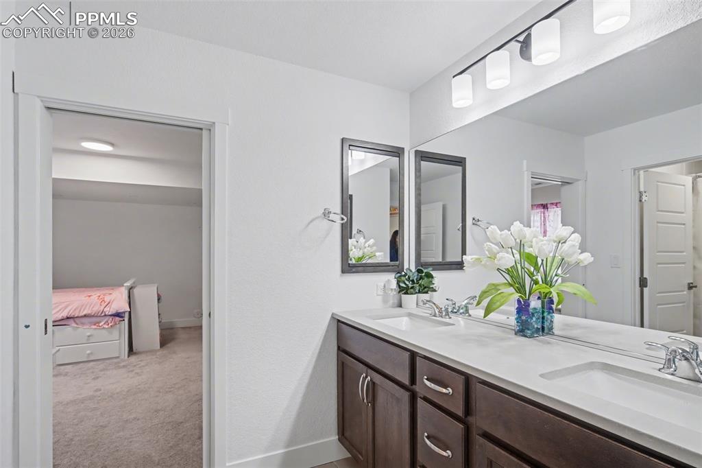 Image 26 of 37: Bedroom with light colored carpet and recessed lighting