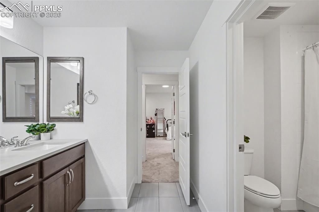 Image 27 of 37: Bedroom with light colored carpet and a closet