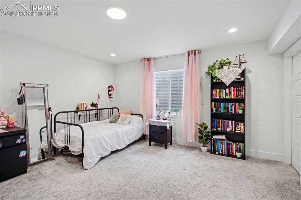 Image 28 of 37: Bathroom with double vanity, connected bathroom, and light colored carpet