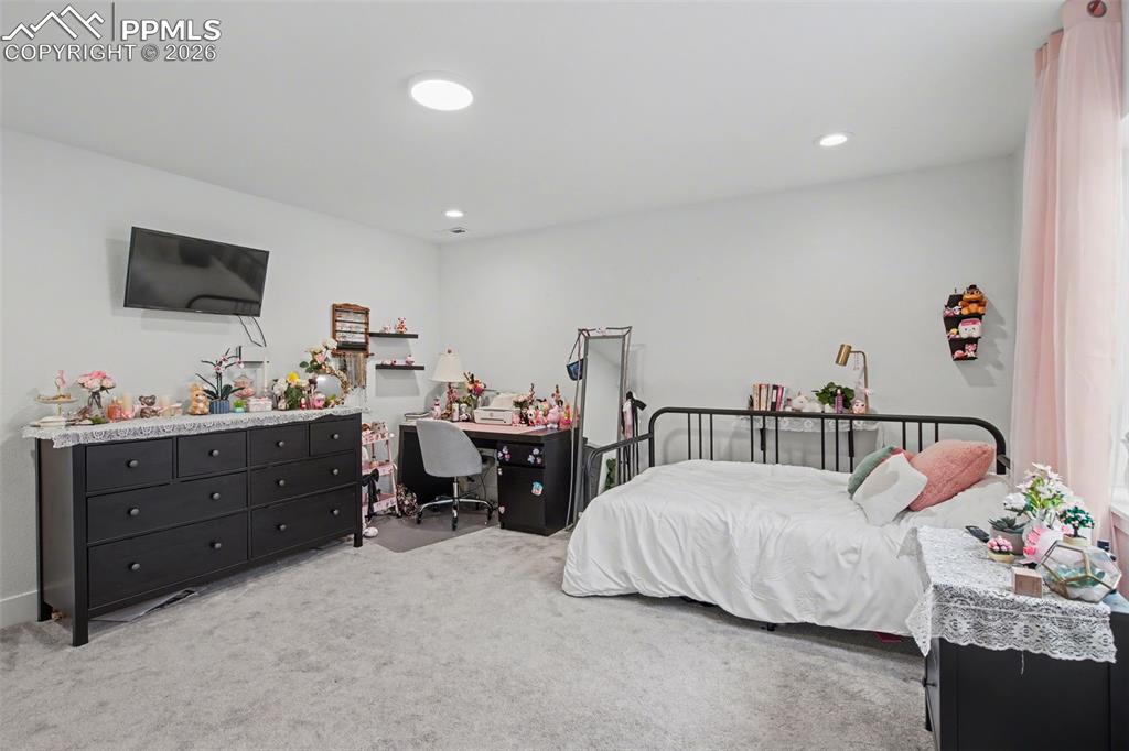 Image 29 of 37: Bathroom with vanity, a shower, light carpet, and light tile patterned floo