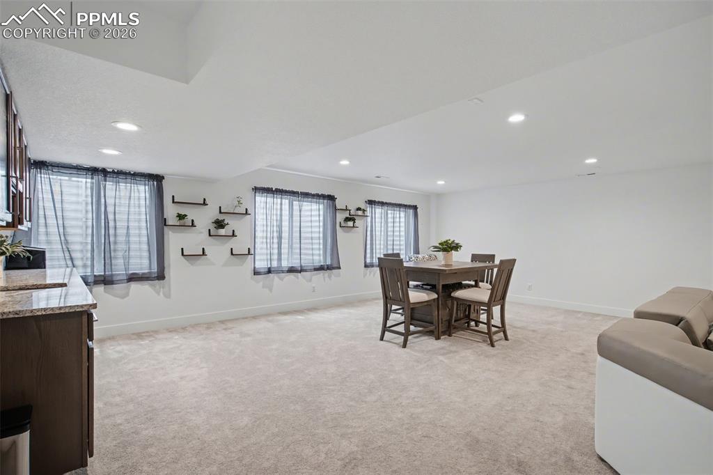 Image 31 of 37: Bedroom featuring an office area, light colored carpet, and recessed lighti