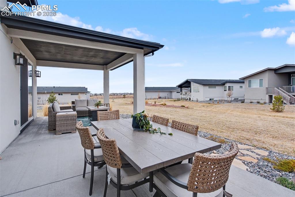 Image 34 of 37: Dining space featuring light colored carpet, wet bar, wine cooler, and rece