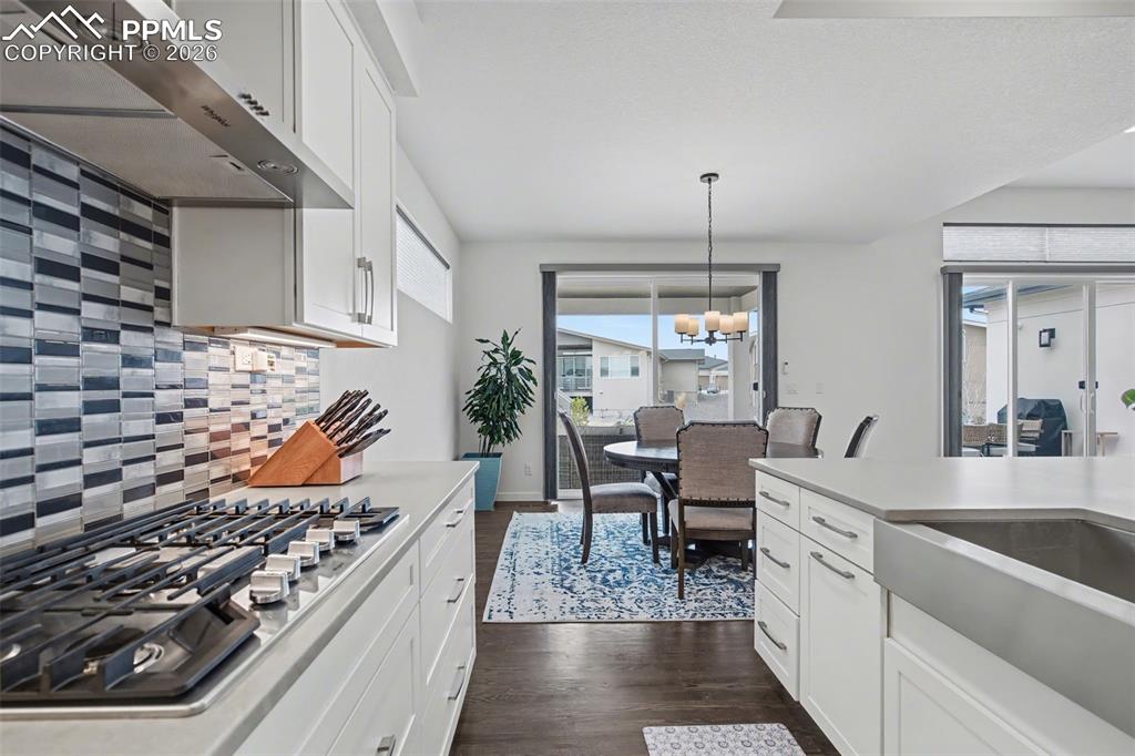 Image 8 of 37: Living area featuring a barn door, recessed lighting, a stone fireplace, an