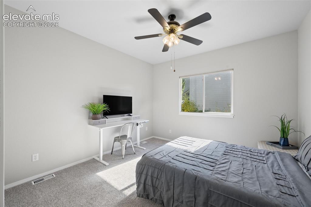 Image 11 of 37: Neutral-toned interior room featuring wall-to-wall carpeting, a multi-light