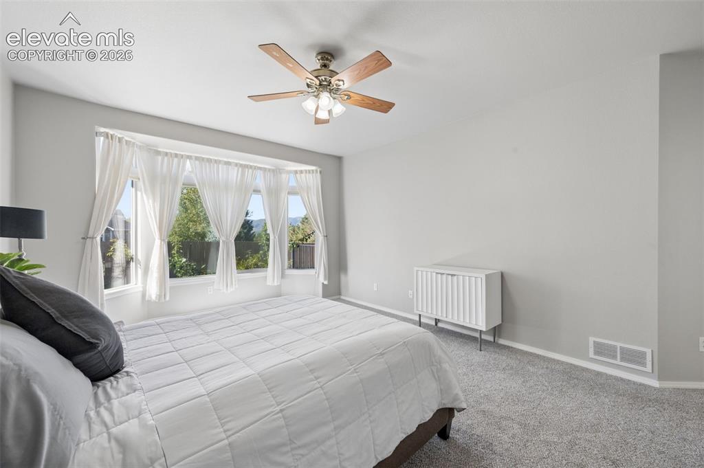 Image 15 of 37: Bay window providing natural light, neutral interior wall paint, and a ceil