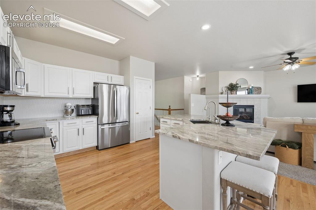 Image 19 of 37: Kitchen featuring white shaker-style cabinetry, stainless steel appliances,