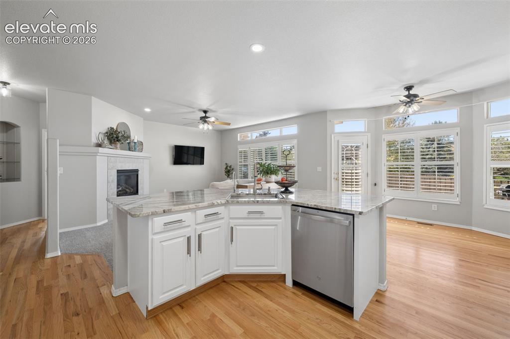 Image 21 of 37: Kitchen island featuring stone countertops, integrated stainless steel dish