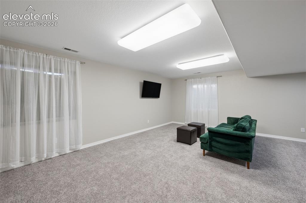 Image 28 of 37: Neutral-toned interior featuring wall-to-wall carpeting, two dual-pane rect