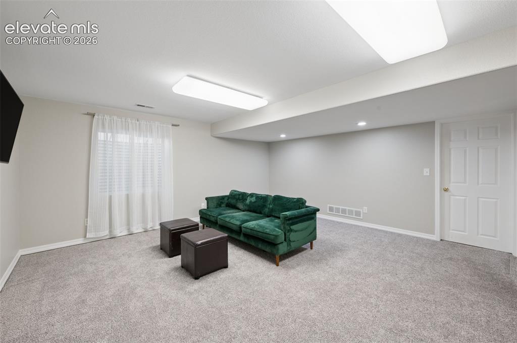 Image 29 of 37: Neutral-toned interior space featuring neutral wall-to-wall carpeting, rece