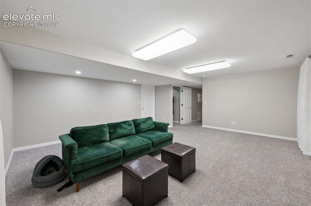 Image 30 of 37: Neutral-toned interior space featuring wall-to-wall carpeting, recessed cei