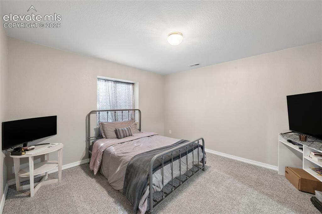 Image 31 of 37: Neutral-toned interior space featuring wall-to-wall carpeting, a single-pan
