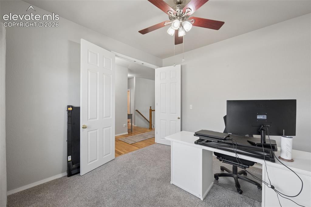 Image 7 of 37: Neutral-toned interior space featuring wall-to-wall carpeting, a multi-ligh